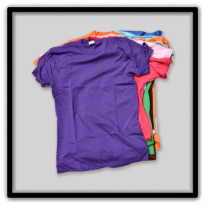 Assorted vintage blank T-shirts laid together with a purple shirt in front.