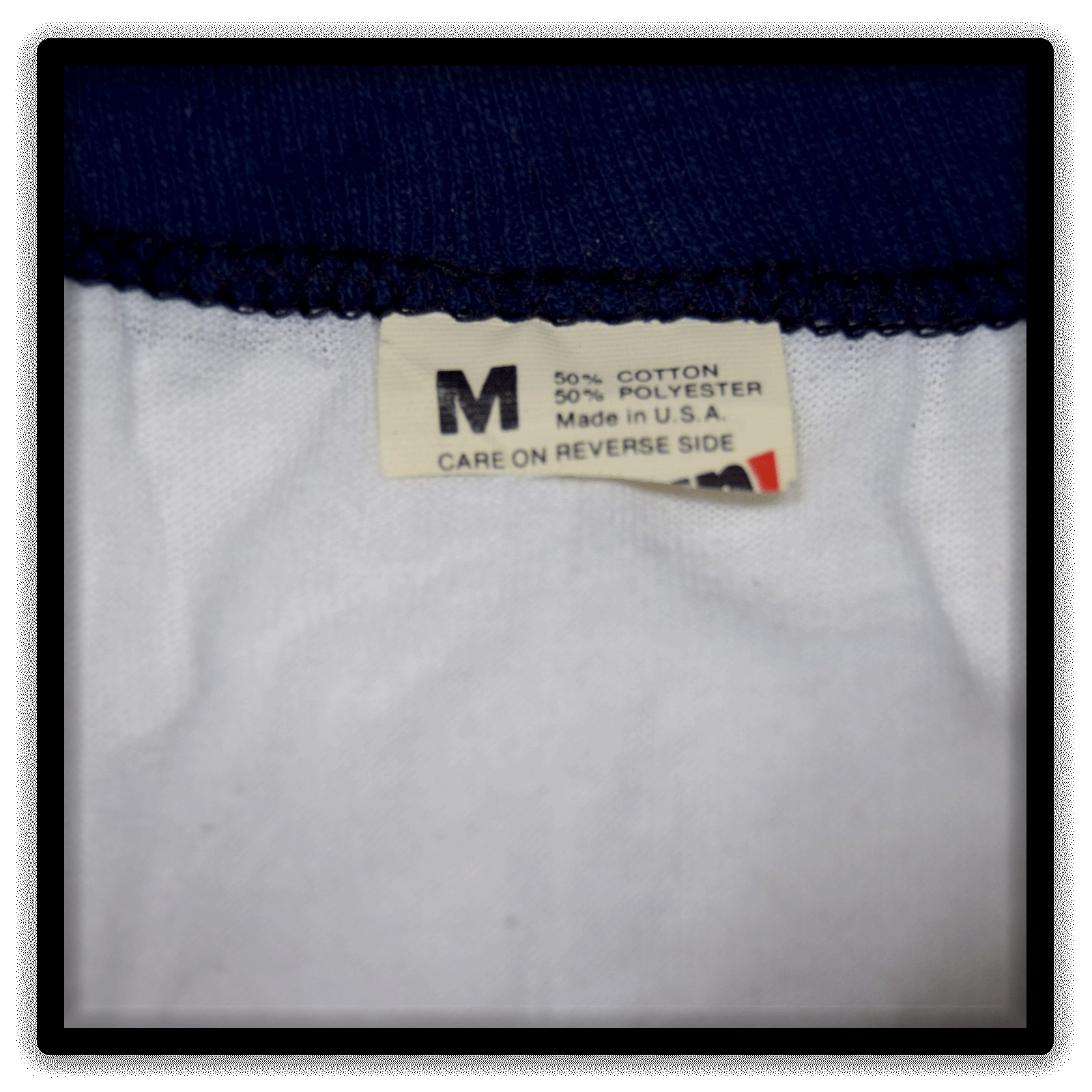Size Medium tag on a white vintage ringer blank T-shirt with navy trim